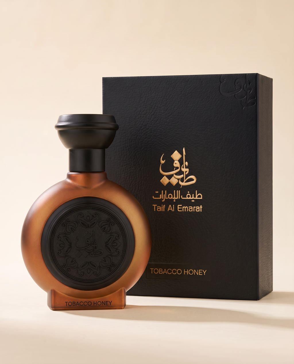 TOBACCO HONEY by Taif Al Emarat: bottle beside its presentation box, on a cream surface