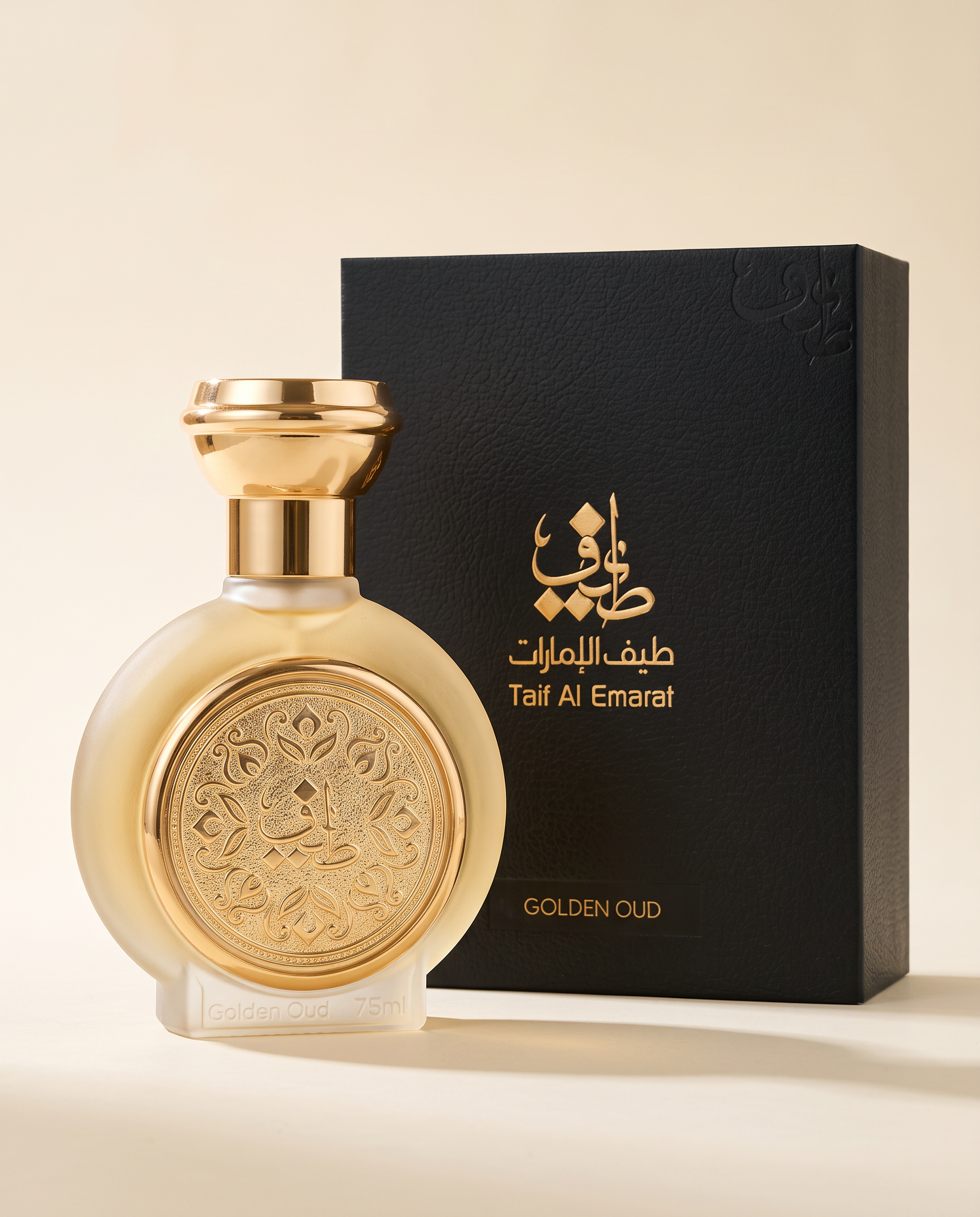 GOLDEN OUD by Taif Al Emarat: the 75ml bottle beside its black leather-textured presentation box with gold Arabic calligraphy, on a cream surface